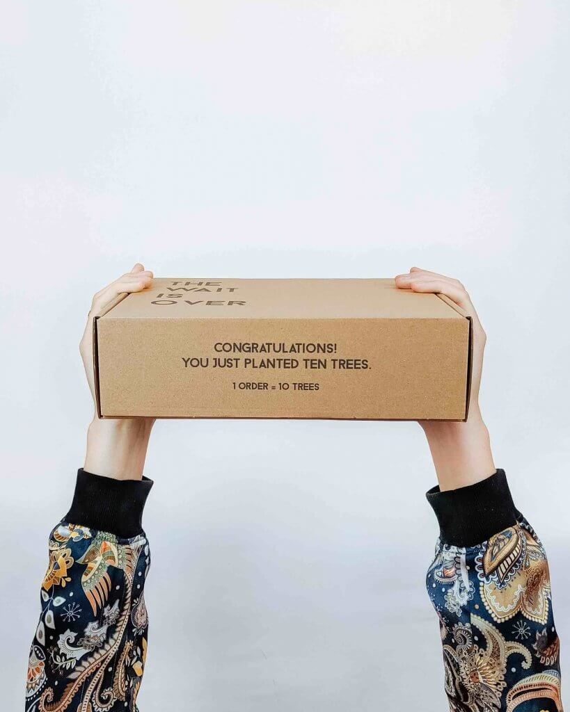 hands holding a corrugated cardboard box