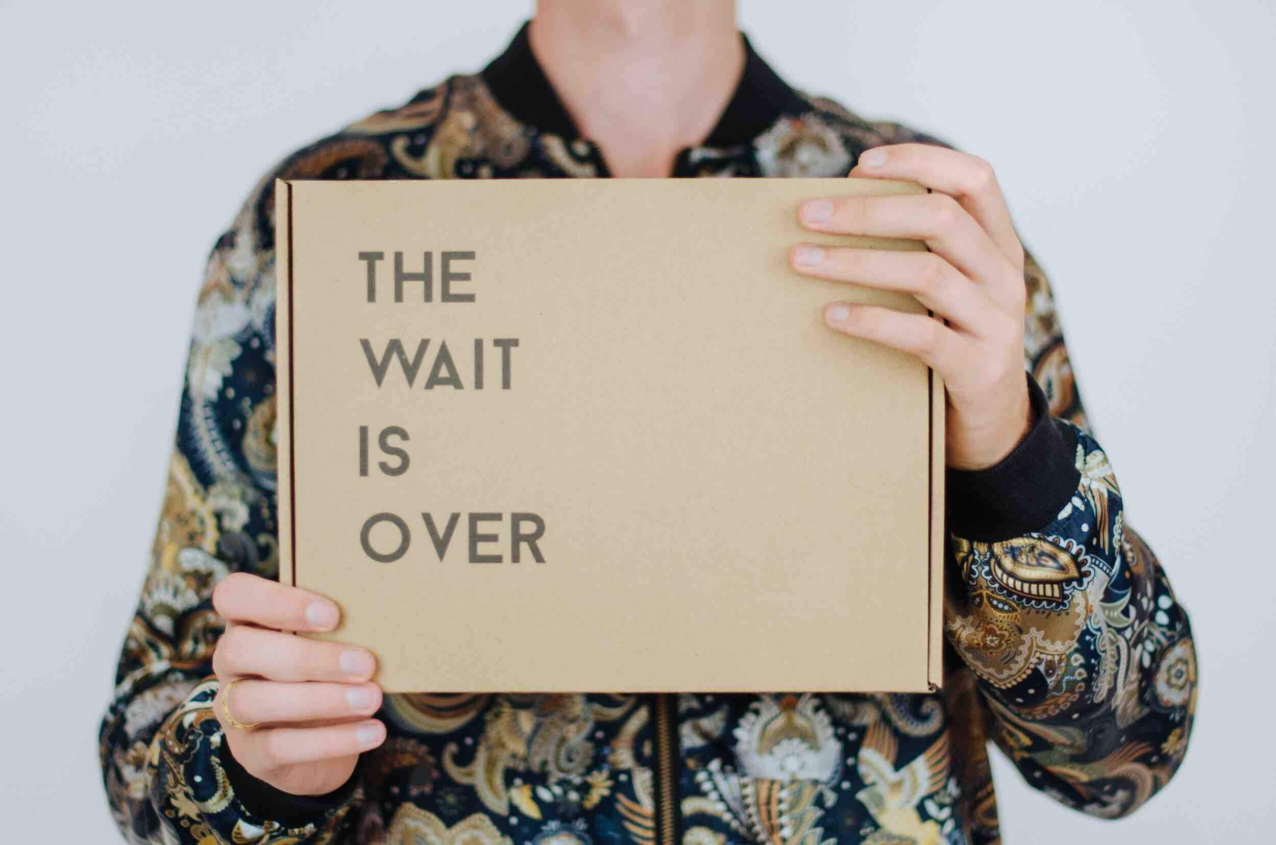hands holding a corrugated printed box by packhelp