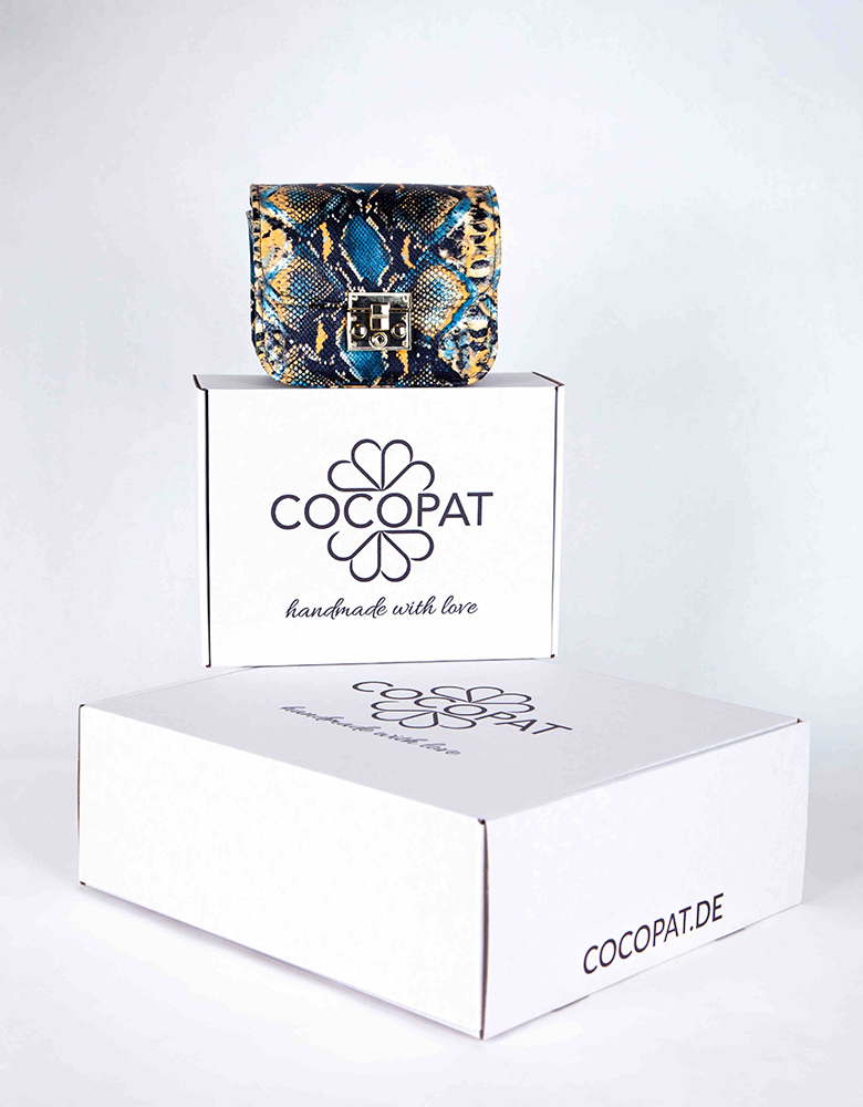 Bunch of white printed boxes with a bag on top