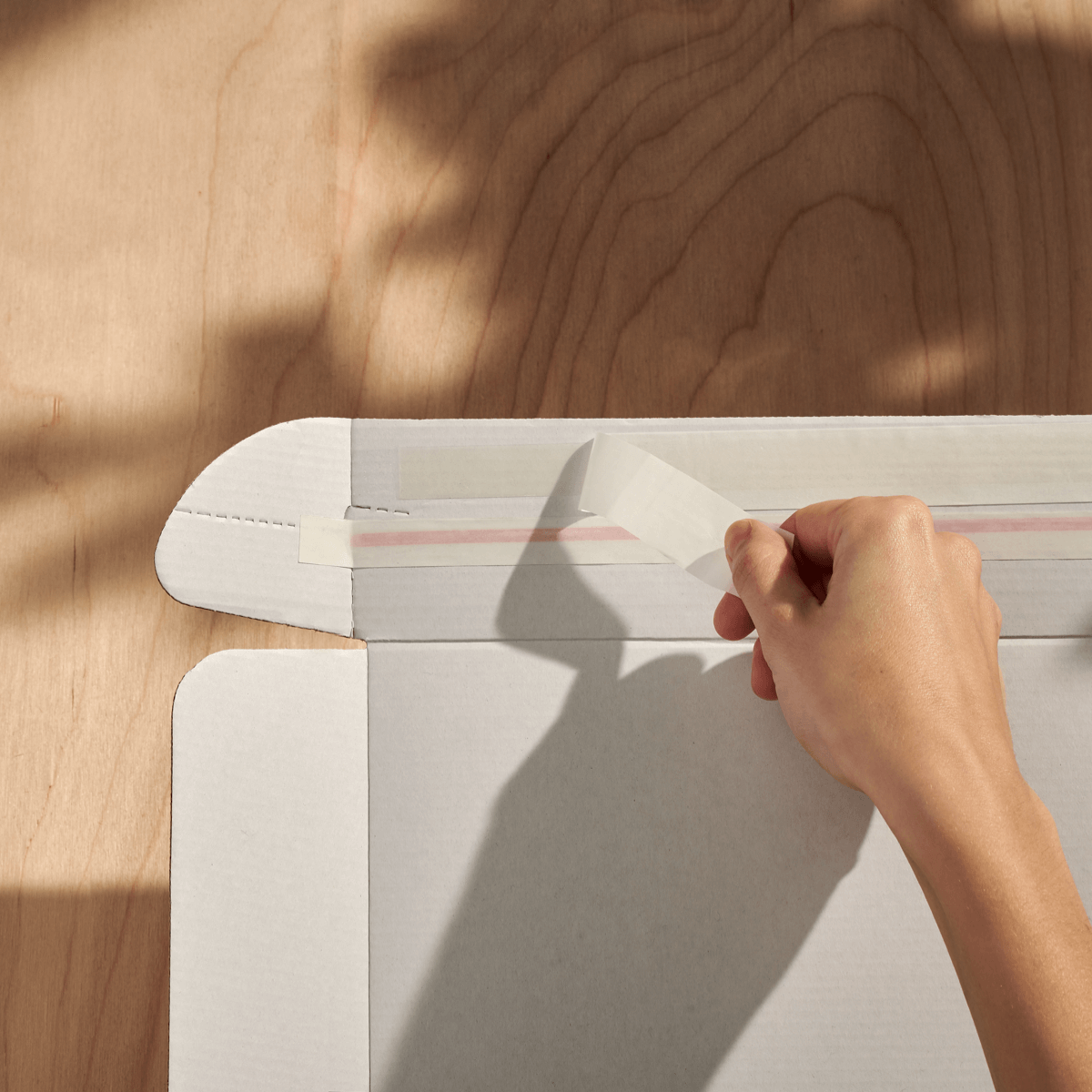 ecommerce delivery box with adhesive strips