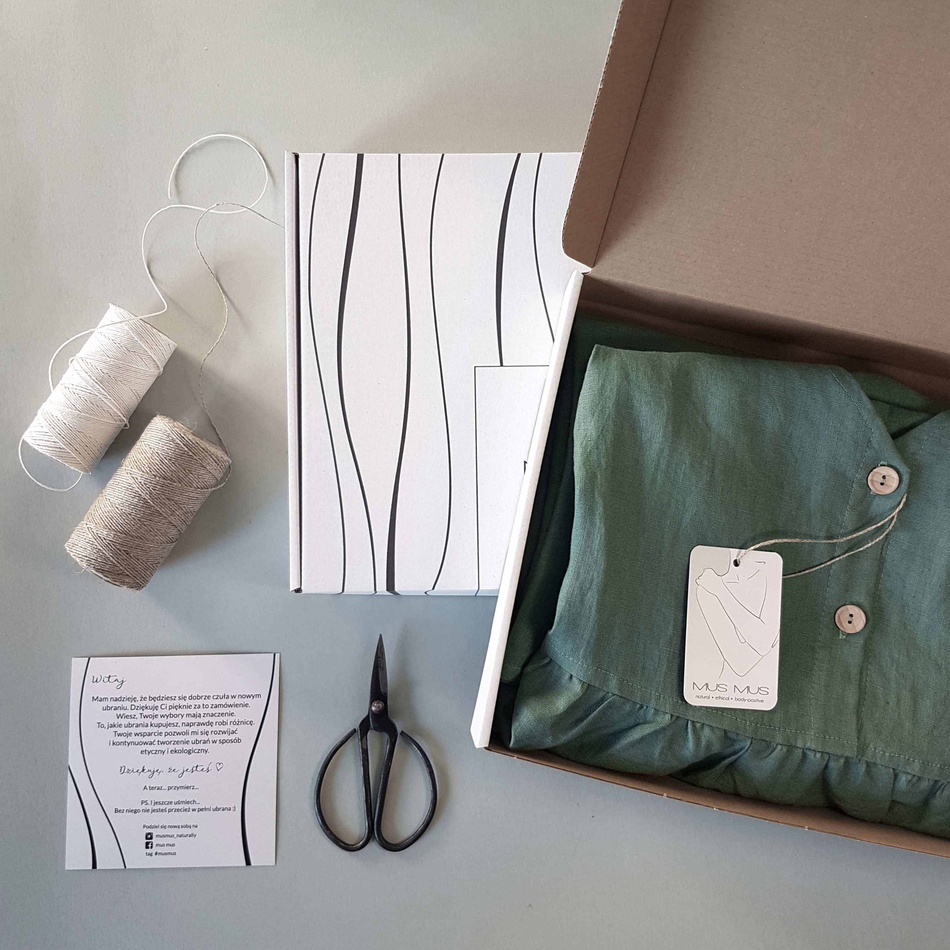 tailoring tools next to a carton box with shirt inside