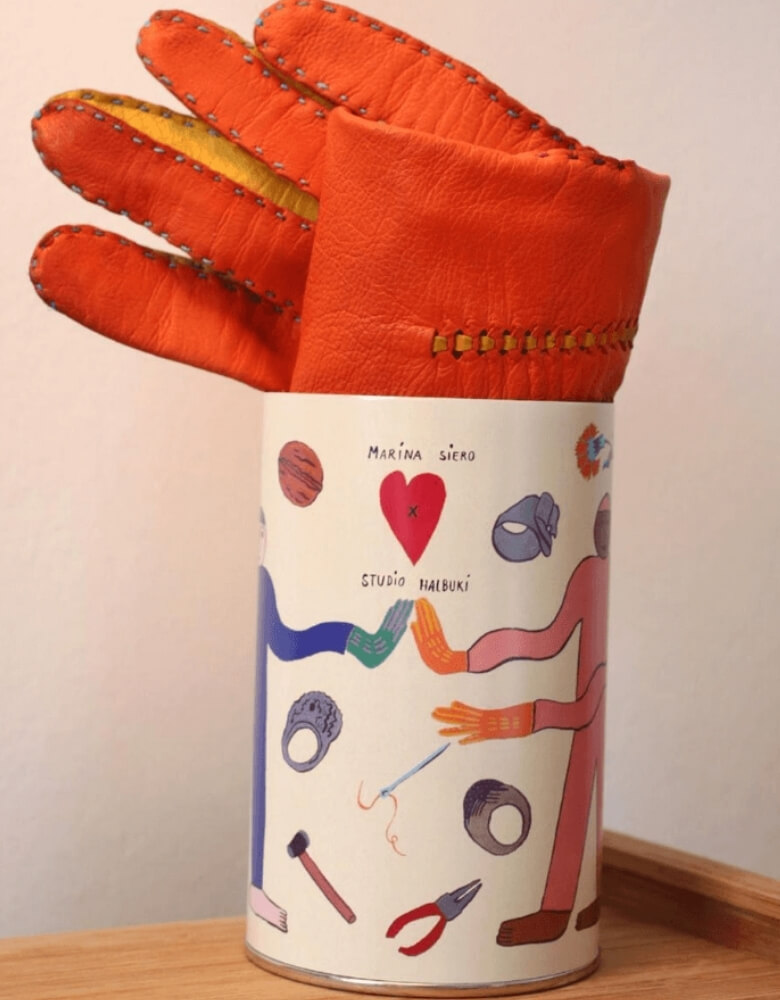 packaging cilíndrico con un guante en su interior