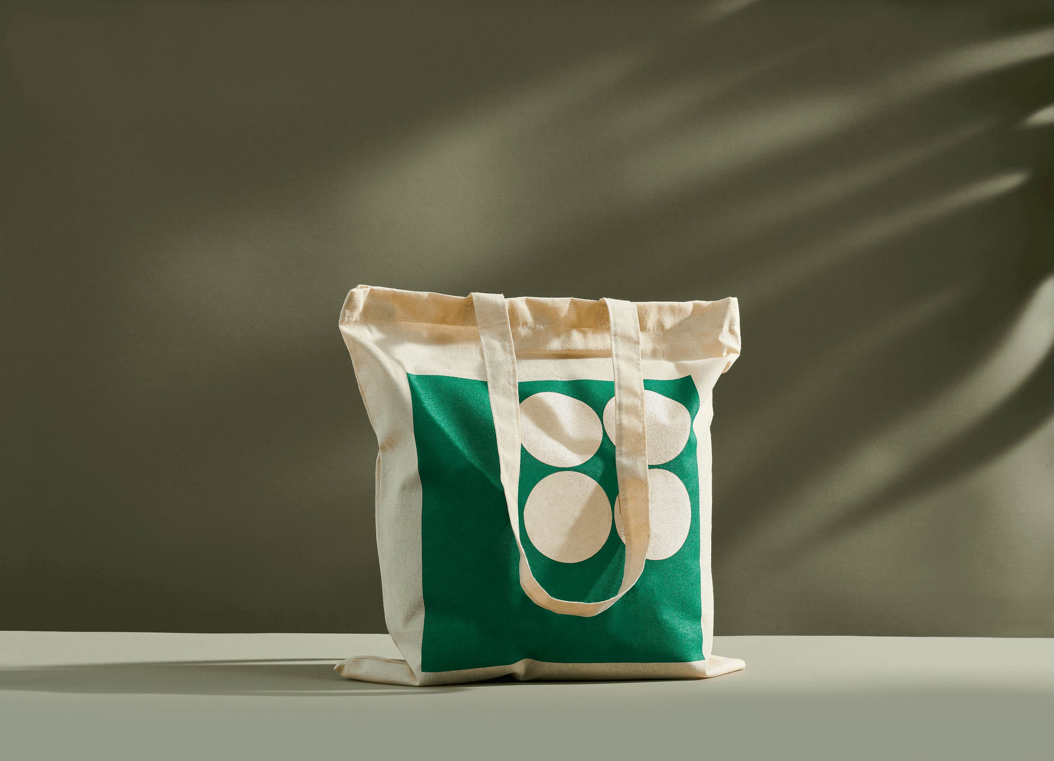 Light beige organic cotton tote bag with green print